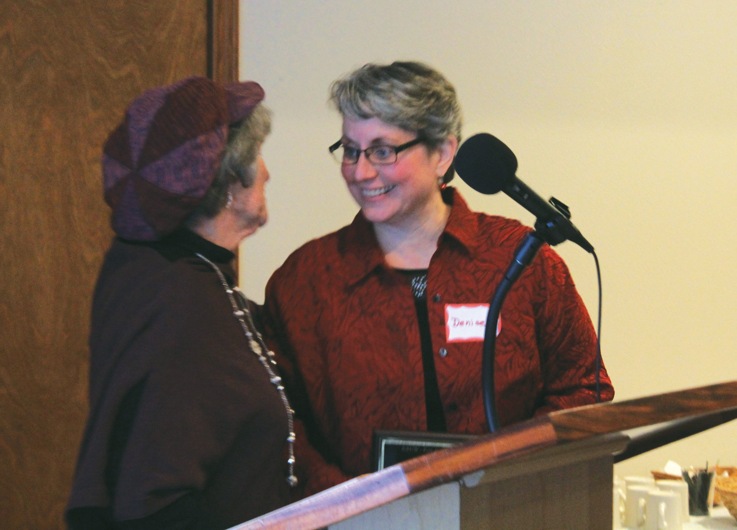 AAUW’s Michael Kubek, left, presents Key City Public Theater Artistic Director Denise Winter with the Woman of Excellence award on Dec. 1.